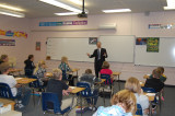 Justice Sandstrom talks with 7th and 8th grade students.