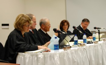 Chief Justice Gerald VandeWalle opens the session of Court at the University of Mary as the justices look on