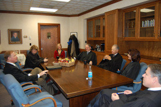 The members of the Court and Law School Dean Kathryn Rand visit with UND President, Robert Kelley