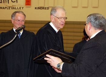 The Court makes a presentation to Enderlin Superintendent Pat Feist.