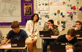 Justice Lisa Fair McEvers chats with students in a classroom.
