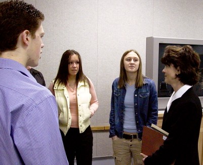 Student guides, Michael Lee, Jillian Robideaux and Danielle Allmaras meet Justice Maring.