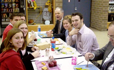 Not wanting to be caught with food in their mouths, Chief Justice VandeWalle and students pause for the photo opportunity.