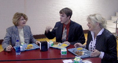 Justice Kapsner enjoys lunch conversation with student Aaron Bjerke and attorney Jonal Uglem