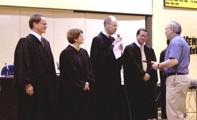 The Court presents Arnold Jordan, Principal, a photograph of the Court