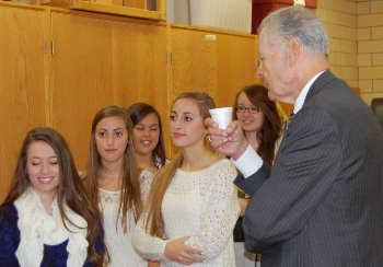 Chief Justice Gerald VandeWalle chats with a group of senior students who greeted the Court on its arrival at Dickinson Trinity High School.