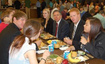 Justice Crothers enjoys lunch with a group of Trinity students.