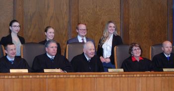 The finalists Alex  Carthew, Emily Ramage, Erica Skogen and Dustin Richard pose with the  Court.  Ms. Skogen was selected as best oralist by the Justices.