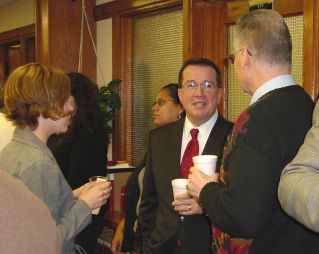 Justice William Neumann makes talks with students and faculty at the reception