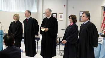 Members of the Supreme Court talk with the audience after the hearing